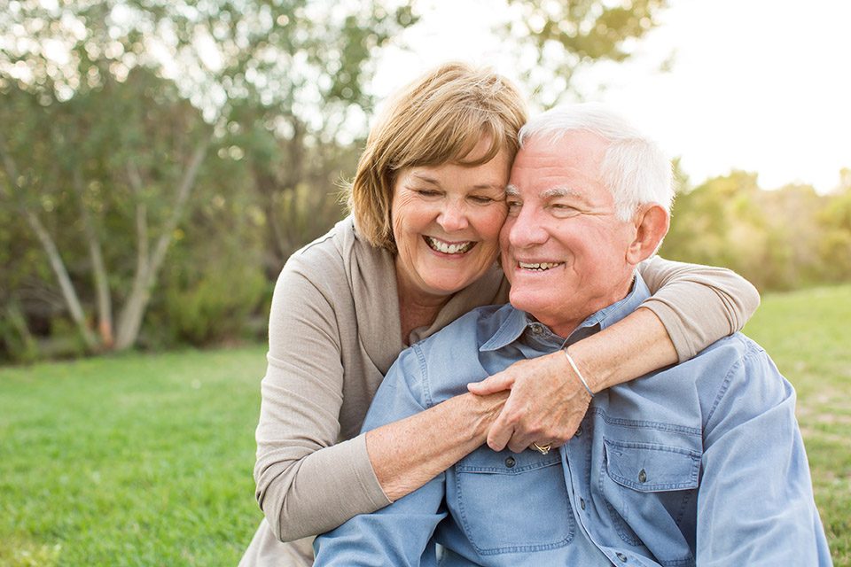 Eldery people hugging and smiling